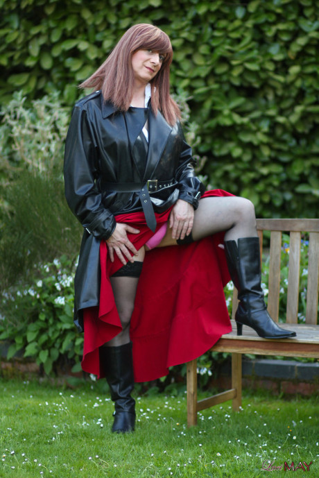 Juicy Luci May wore her fine lovely long rubber trench coat and a long red skirt
