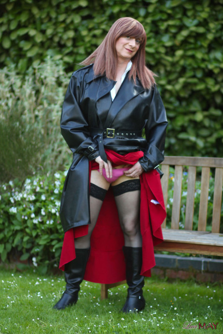 Juicy Luci May wore her fine lovely long rubber trench coat and a long red skirt