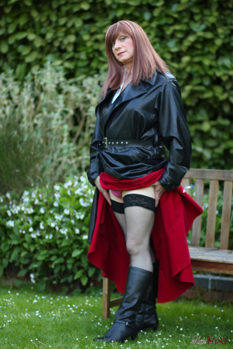Juicy Luci May wore her fine lovely long rubber trench coat and a long red skirt