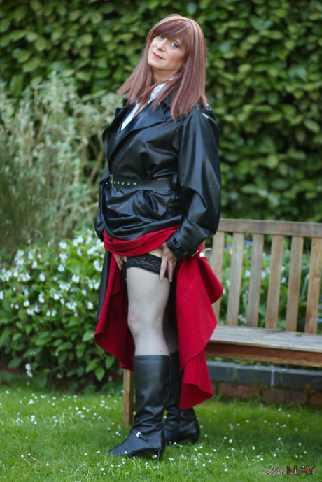 Juicy Luci May wore her fine lovely long rubber trench coat and a long red skirt