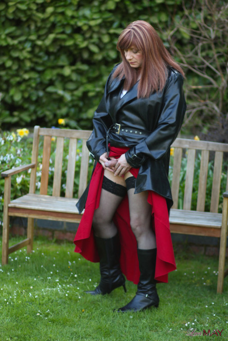 Juicy Luci May wore her fine lovely long rubber trench coat and a long red skirt