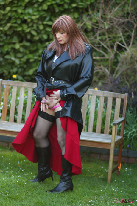 Juicy Luci May wore her fine lovely long rubber trench coat and a long red skirt