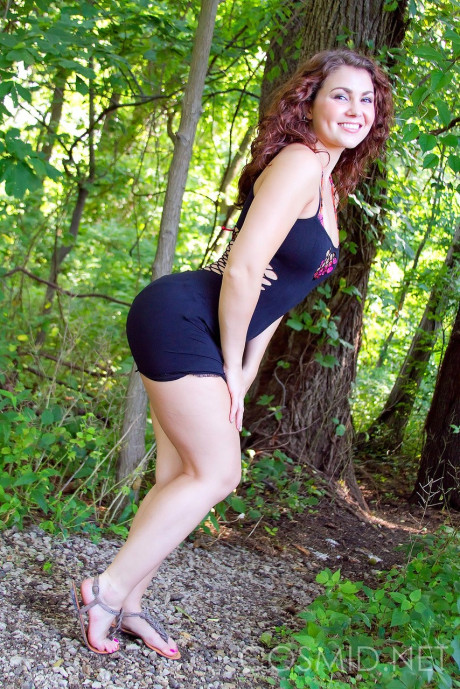 Curvy lovely skank girl lady slips out of her tight dress to show her boobs in the woods