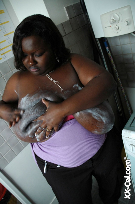 Mature BBW black Mariana Kodjo oiling & massaging her humongous tits