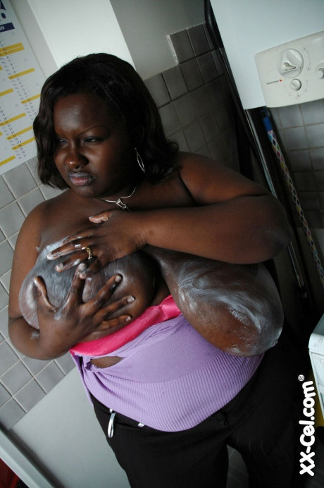 Mature BBW black Mariana Kodjo oiling & massaging her humongous tits
