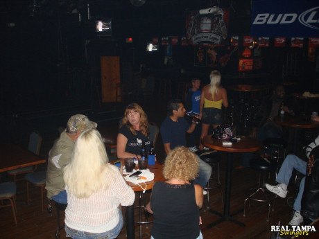 Yellow-haired amateur cougar shows her shaved clam in the swinger night club