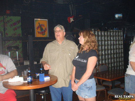 Yellow-haired amateur cougar shows her shaved clam in the swinger night club