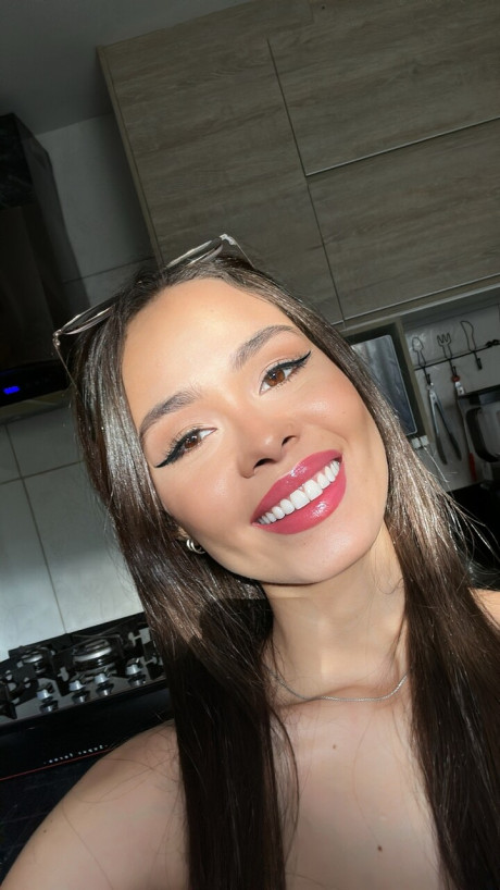 Pretty brunette Nina Carvalhoo sports a winning smile during a SFW shoot