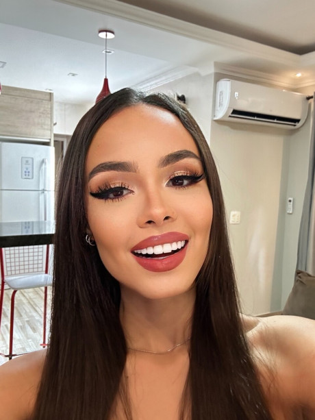 Pretty brunette Nina Carvalhoo sports a winning smile during a SFW shoot