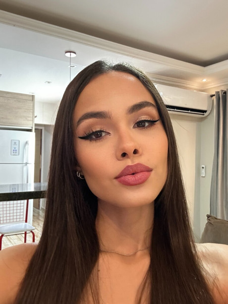 Pretty brunette Nina Carvalhoo sports a winning smile during a SFW shoot