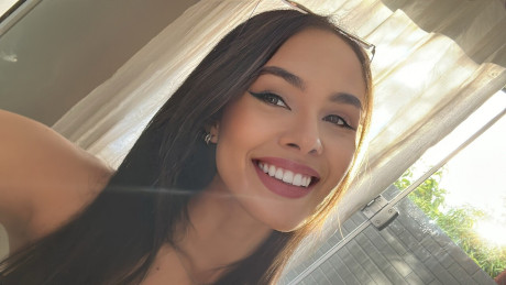 Pretty brunette Nina Carvalhoo sports a winning smile during a SFW shoot