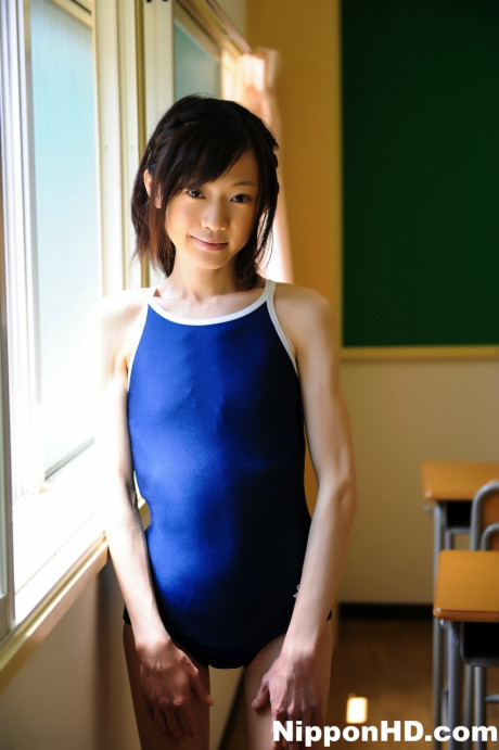 Tiny Japanese skank girl girl model non nude in a swimsuit on school desk