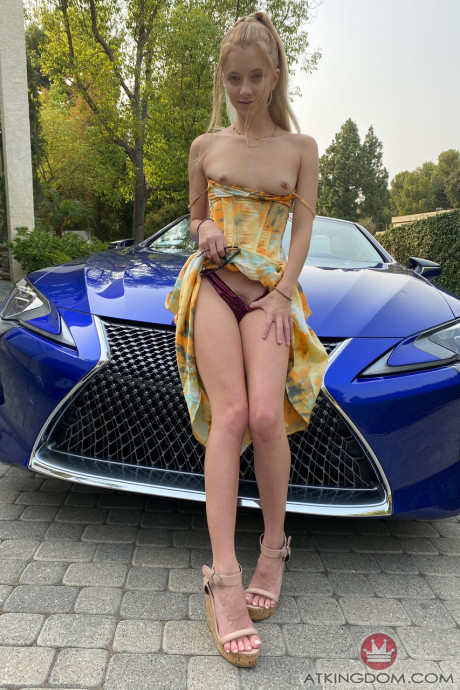 Tiny babe Riley Star shows her large clit and spreads her booty in a convertible