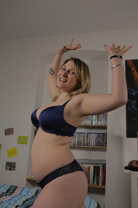 Yellow-haired German skank broad poses booty naked on her bed before getting dressed
