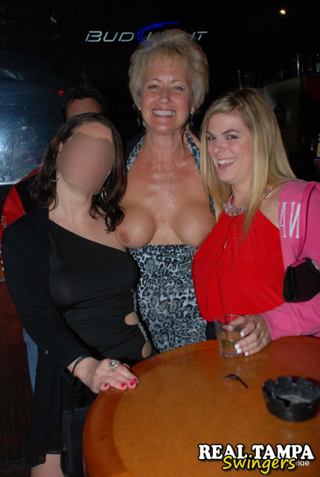 Mature swinger Tracy lick reveals her large juggs and gets blacked at a club