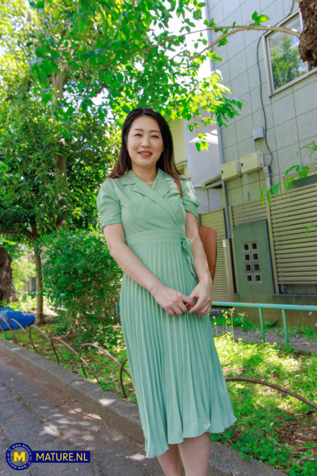 Japanese MILF Megumi Satuki shows her body and poses on a couch