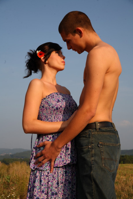 Horny fresh young couple has sex on a mound of loose straw in a field