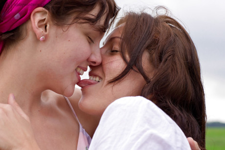 Fresh young ladies Gina J and Immie tongue kiss and lap furry pussy outside