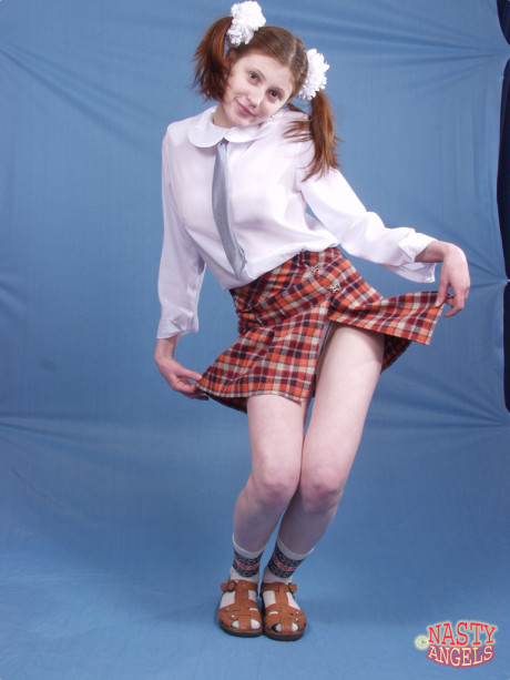 Pigtailed schoolgirl Dasha exposes her juicy huge boobs and fine clitoris