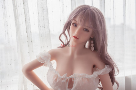 Adorable sex doll Chika showing her perfect boobies and bald twat in the bedroom