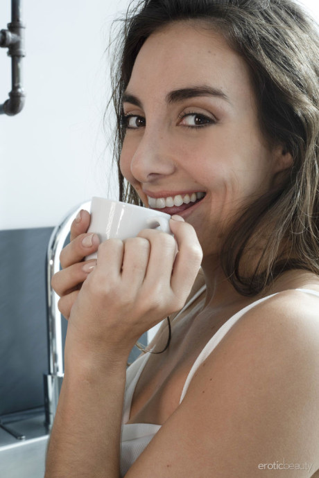 Brunette teenie Ana Bb gets completely undressed in a playful fashion