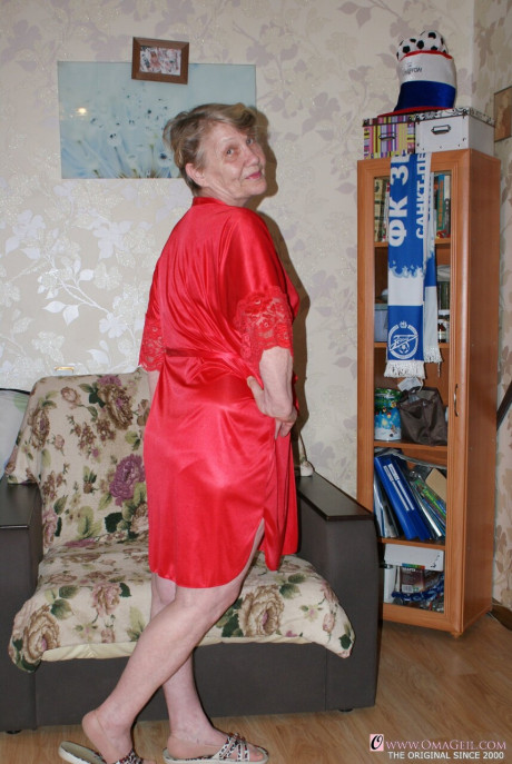 Yellow-haired old lady Belly loses her red undies & shows her saggy melons & furry pussy