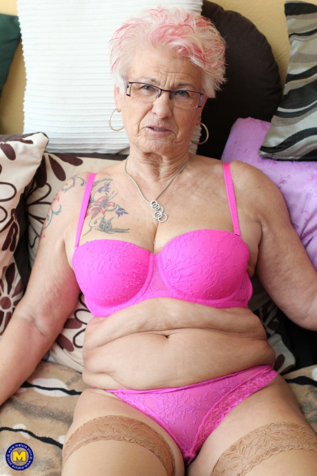 German grandmother Gerdi strips & spreads her attractive shaved mature vagina on a bed