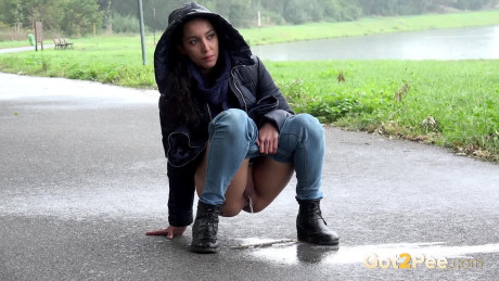 Beautiful dark haired babe pees on the ground