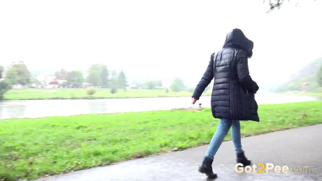 Beautiful dark haired babe pees on the ground
