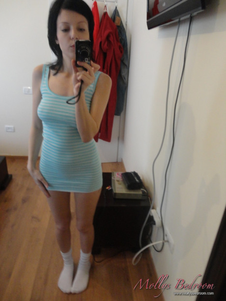 Fresh teenie looking brunette takes self shots while exposing herself in white socks