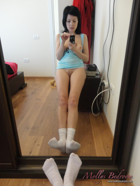 Fresh teenie looking brunette takes self shots while exposing herself in white socks
