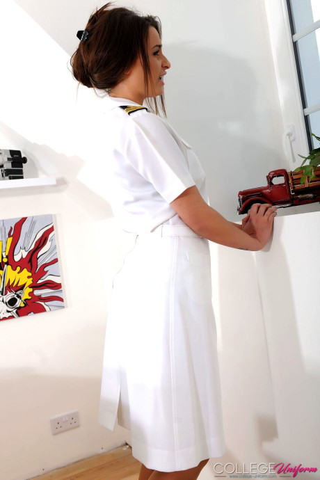 Brunette pilot Sarah Louise strips her uniform and poses in her undies