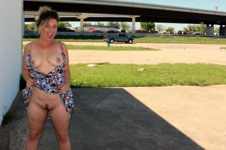 Wild housewife June Larue goes for a walk in public with behind plug in behind