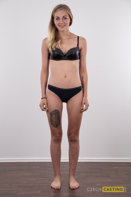 Blonde young Marcela shows her very tiny breasts wearing a black thong