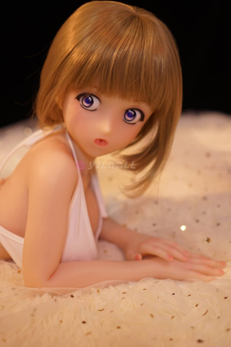 Cute sex doll models on a bed in a thong and micro bikini top