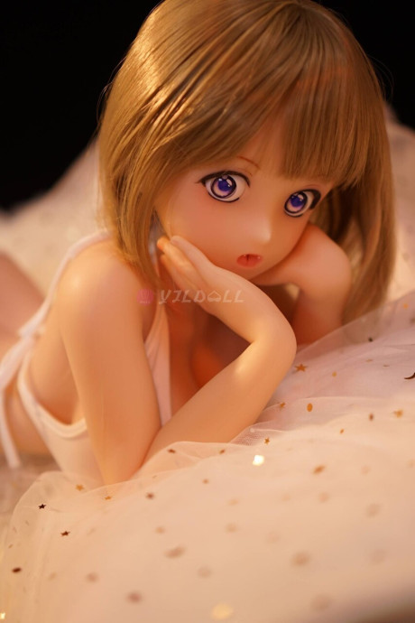 Cute sex doll models on a bed in a thong and micro bikini top