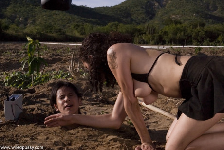 Buried babe Nadia Styles gets tortured by a nasty curly haired female