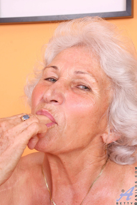 Grey haired old lady Betty exposes her saggy juggs and fingers her clam