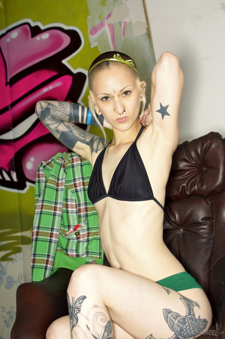 Skinny inked fetish freak with shaved head & snatch sucks dildo & toys nude