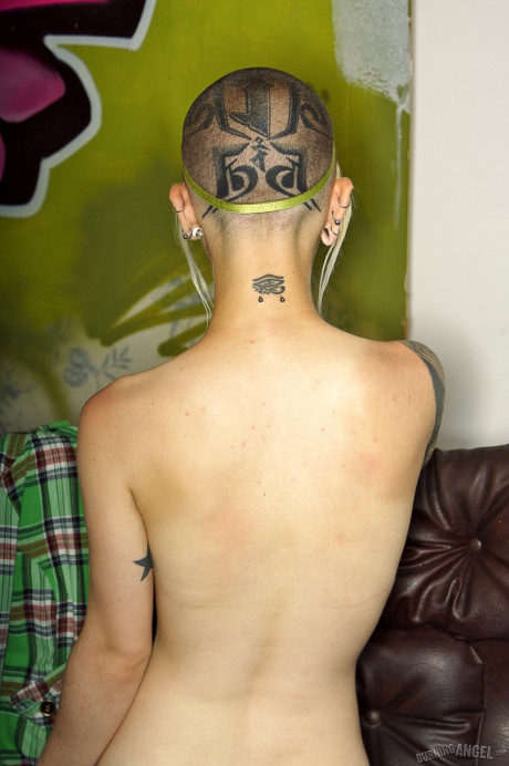 Skinny inked fetish freak with shaved head & snatch sucks dildo & toys nude