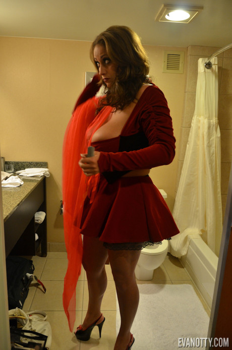 Buxom pornstar Eva Notty teases in little red riding hood costume & gets undressed