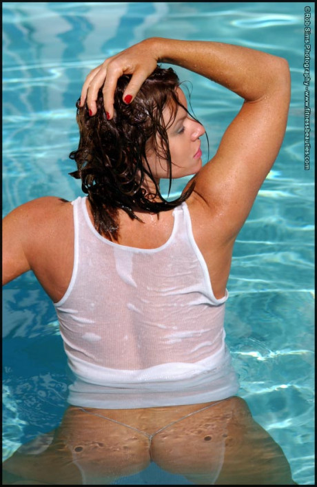 Pretty middle-age chick Tonya Elliott models a wet tank top in a pool