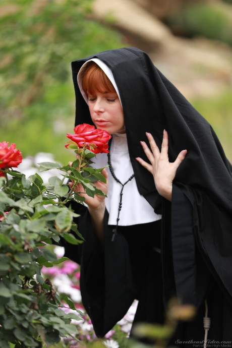 Redheaded nun Penny Pax shows off her large natural titties and and snatch