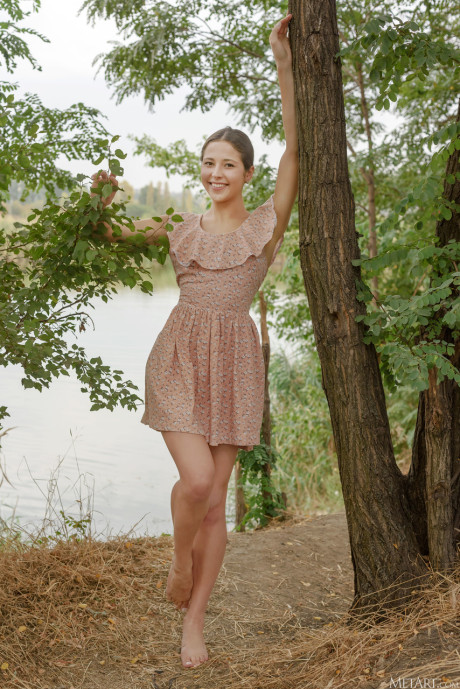 Thin brunette Mattie stripping naked and spreading her cunt under a tree