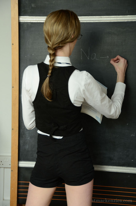 Petite blondy bookworm in glasses getting nude in the classroom