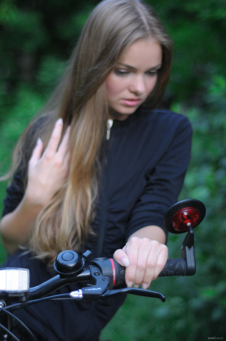 Ravishing teenie babe Bridgit A riding her bicycle pantyless in nature