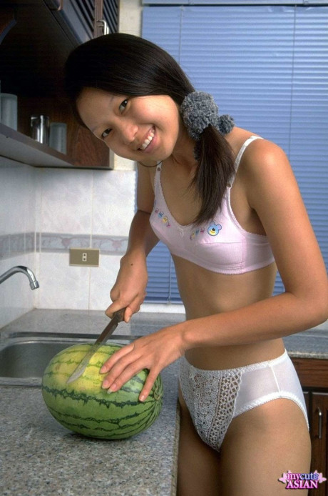 Pretty chinese teen removes lace undies while eating a watermelon