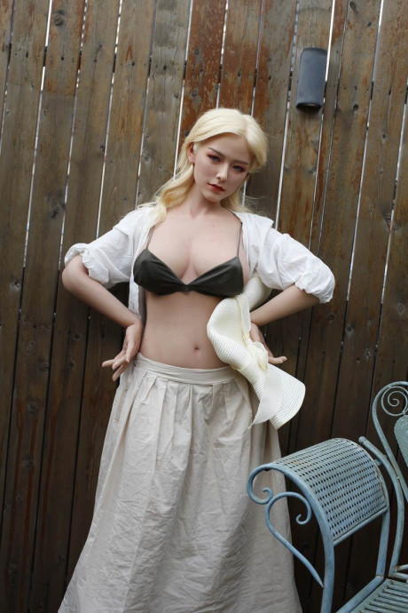 Blondy sex doll Divina flashes a pantiless upskirt and poses buck nude