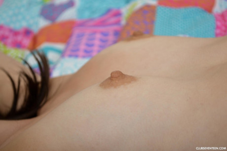 Petite brunette teenie Emily G unveils her hard nips and plays with a vibrator