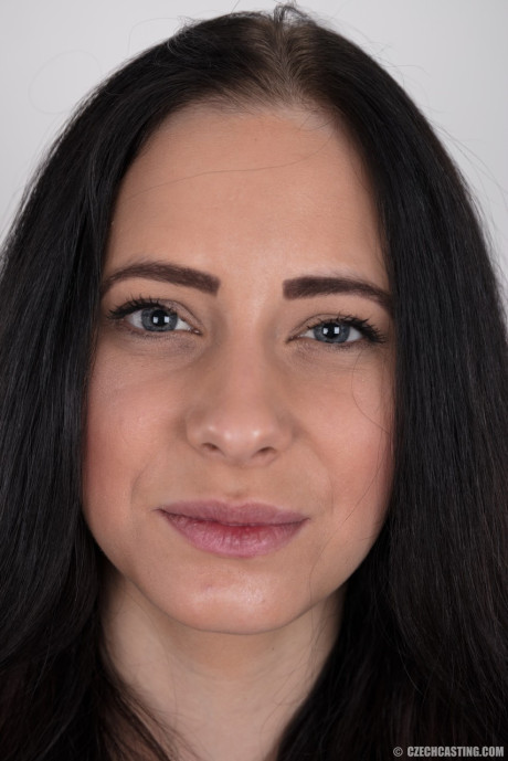 Dark haired female with a firm face model in the undressed for the first time